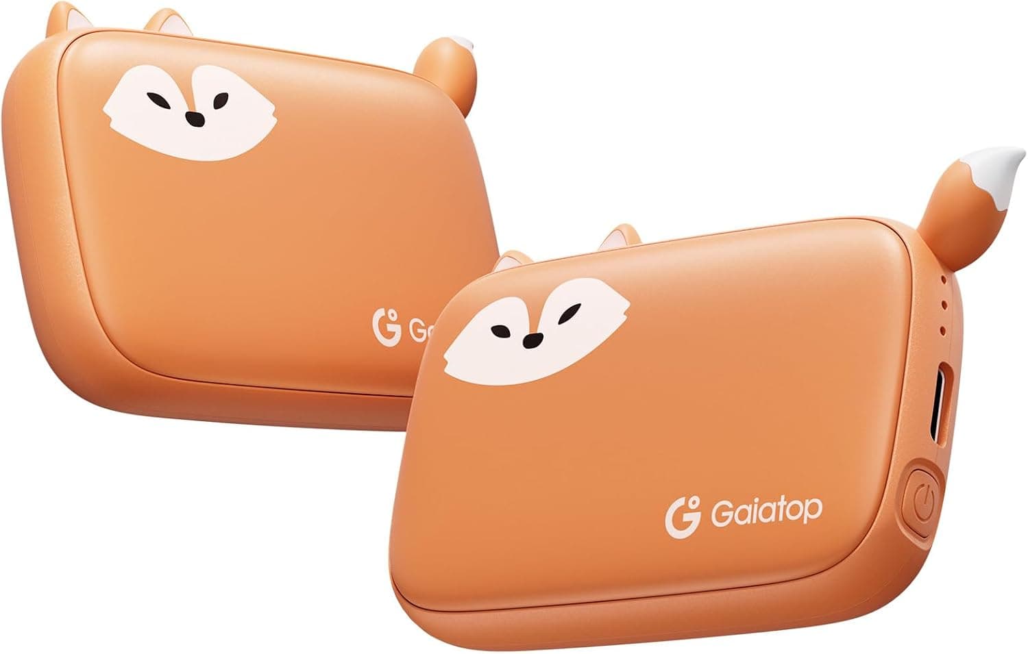 Two small orange rechargeable hand warmers with fox faces, ears and a tail