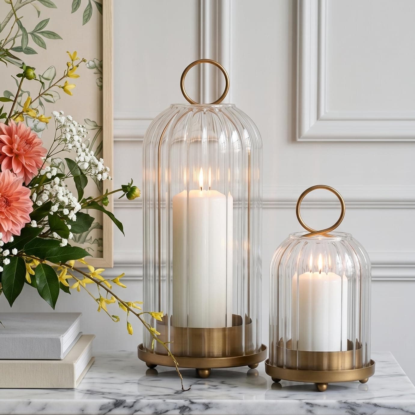 Two brass-coloured metal lanterns with ribbed glass domes on a dark wood hall table, each holding a pillar candle