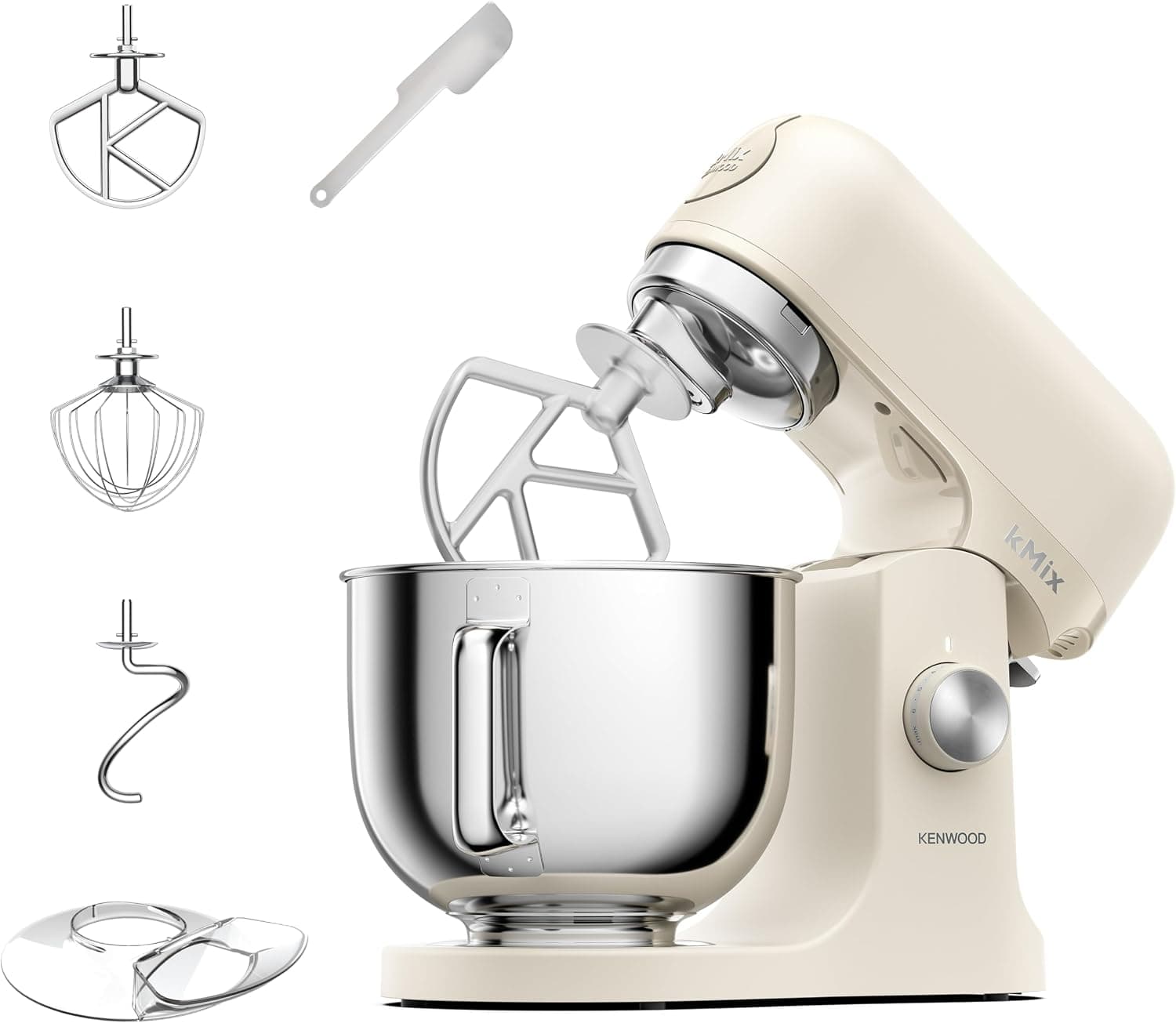 A cream Kenwood kMix stand mixer with a steel bowl, shown with its beater, whisk, dough hook and splash guard