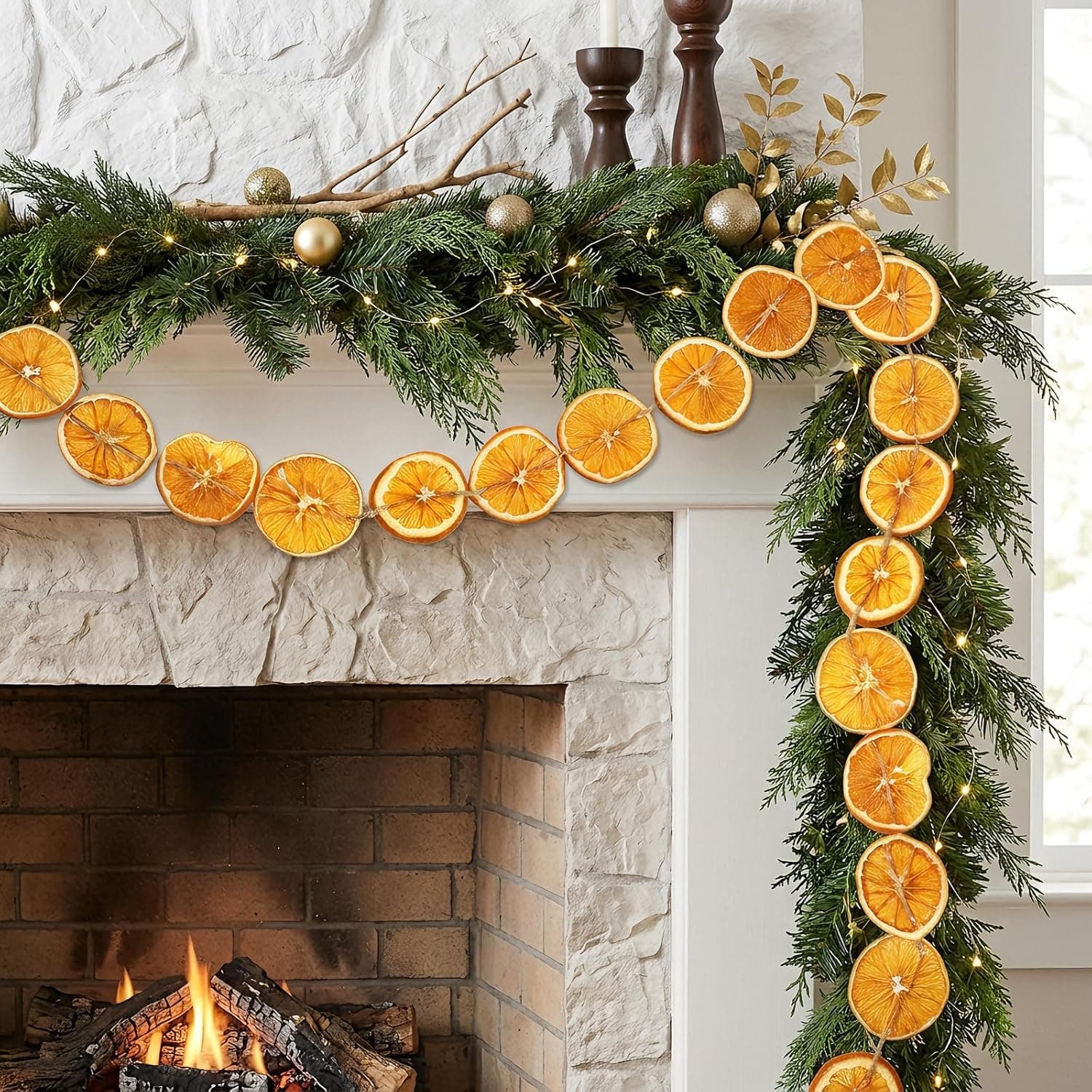 A 1.8m garland of real dried orange slices on jute twine draped along a dado rail in a dark green hallway