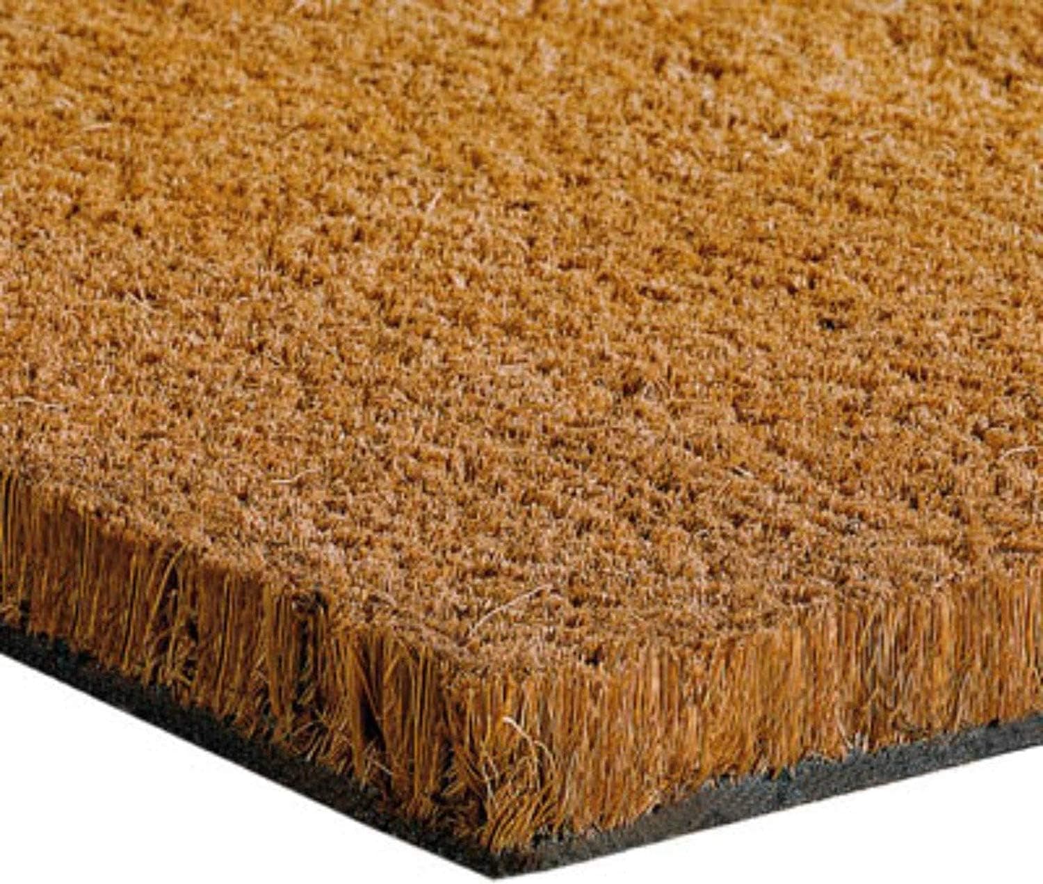 A plain thick coir doormat, 50cm by a metre, lying on encaustic tiles inside a Victorian front door