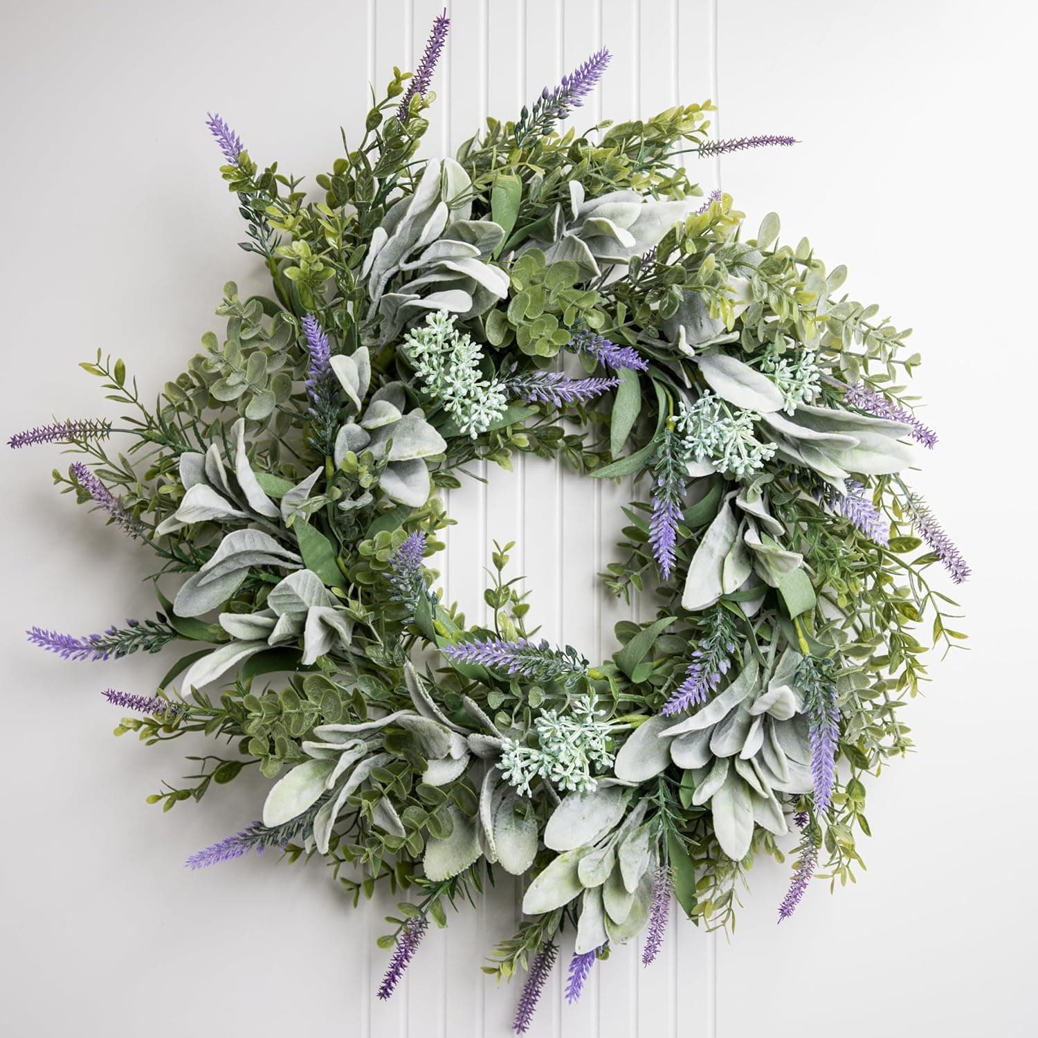 A 50cm artificial wreath of soft grey-green lambs ear, lavender sprigs and eucalyptus hanging on a pale painted front door