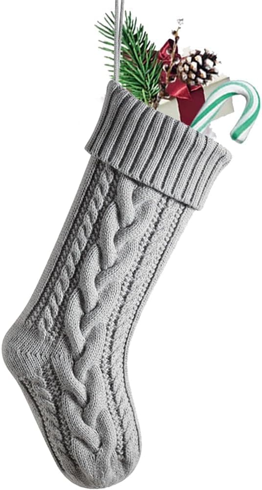 A single light grey cable-knit Christmas stocking with a deep ribbed cuff and a hanging loop, on white