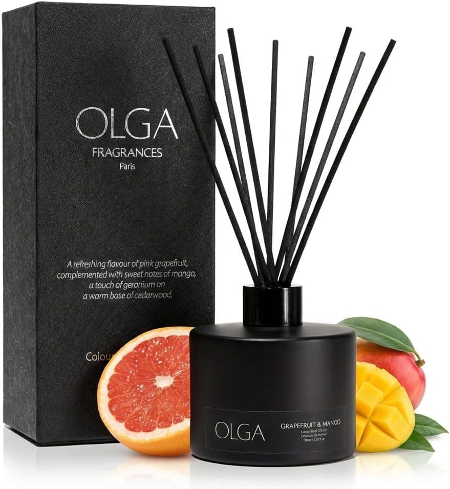 A black glass reed diffuser bottle with a fan of dark reeds, beside its gift box